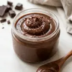 Delicious homemade chocolate pudding in a bowl topped with whipped cream