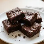 Greek Yogurt Brownies served on a plate with chocolate drizzles