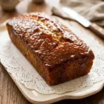 Gluten-free Moist Lemon Yogurt Cake topped with lemon zest and fresh fruits